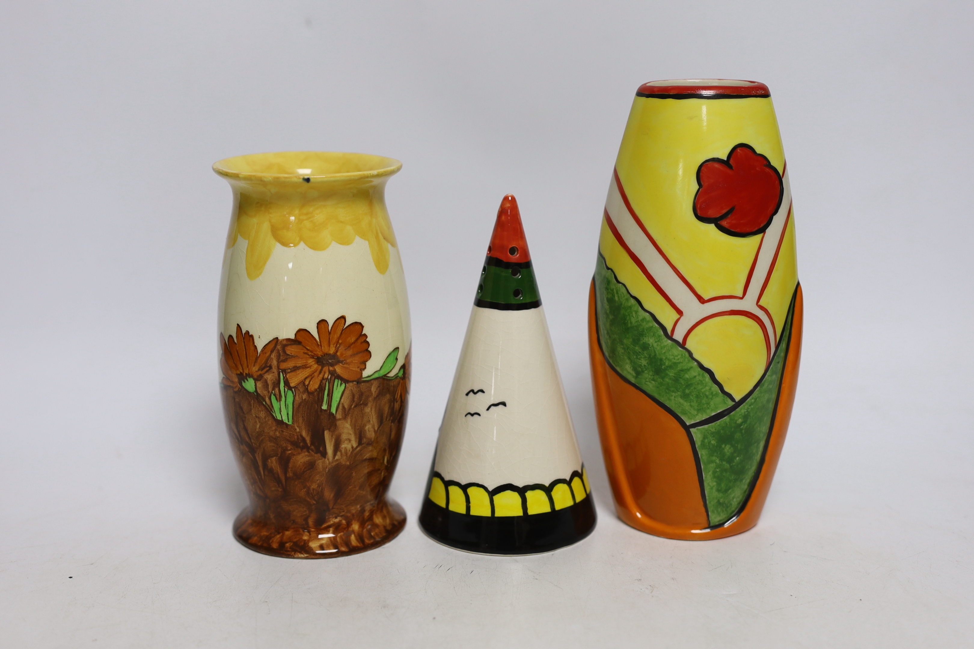 A Bernadette Eve “House” hand painted conical sugar sifter, a limited edition Heron Cross “Sunny Meadow” vase painted by Denise Steele 30/100 and a Burslem “Memory Lane” vase, all in Clarice Cliff style, tallest 18.5cm